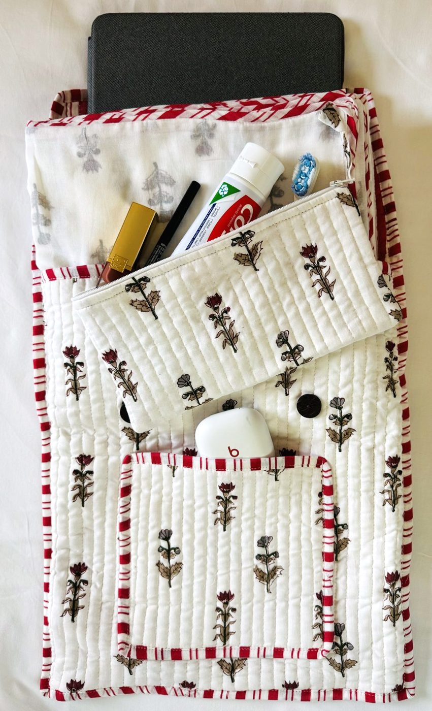 Large pouch packed with a tablet, toothpaste, pens and earbuds
